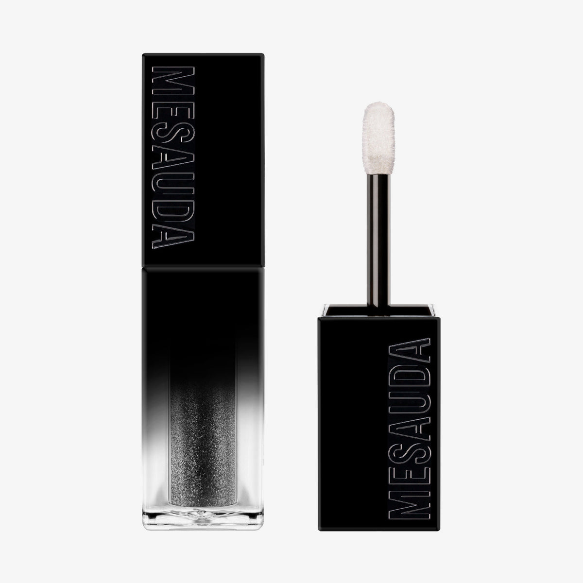 Der Galactic Shadow Flüssigliedschatten von Mesauda Beauty in einer rechteckigen Tube mit dem Deckel und Applikator daneben.
