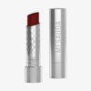 Eine silberne, geöffnete tube des Messauda Beauty Hydramorphosis Lippenstifts, der Deckel steht daneben.
