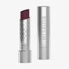 Eine silberne, geöffnete tube des Messauda Beauty Hydramorphosis Lippenstifts, der Deckel steht daneben.
