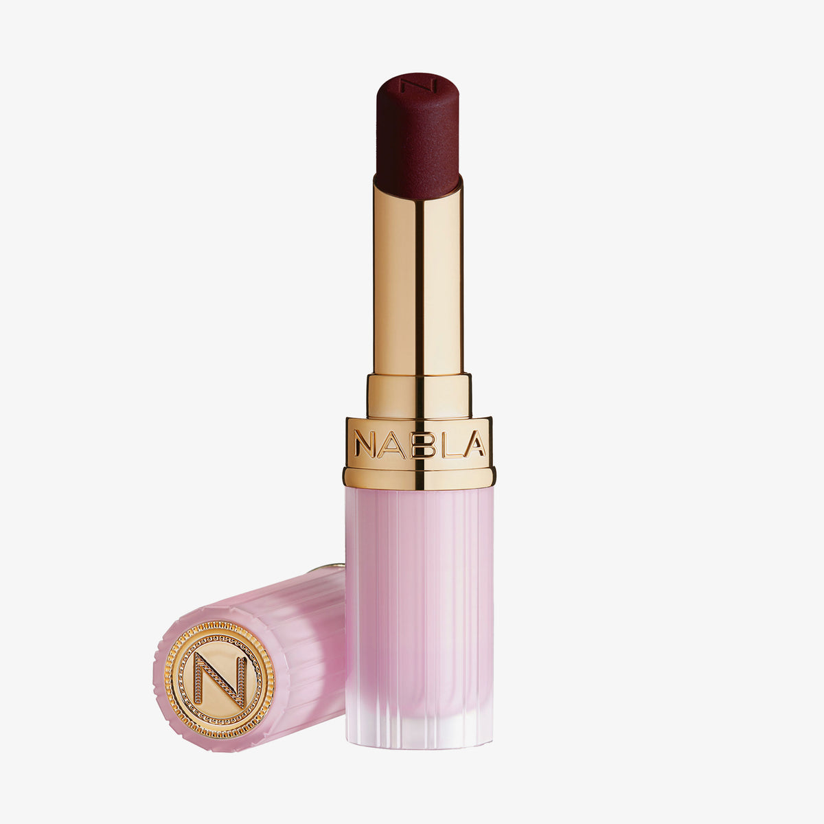 Der Beyond Blurry Lipstick in der Farbe nocturna wird in einer rosa-goldenen Tube mit ausgefahrenem Lippenstift und daneben platzierter Kappe gezeigt.