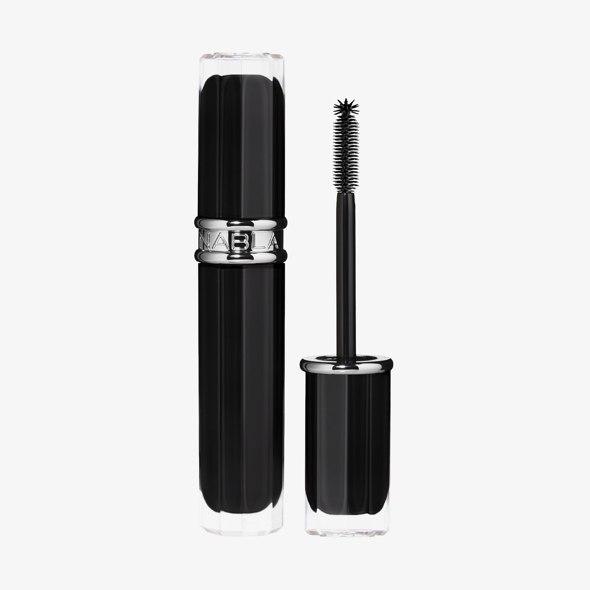 Beyond Bold Mascara von NABLA Cosmetics, in einer schwarzen Tube mit silbernen Akzenten, wird mit abgenommener Kappe und aufrecht stehendem Applikator präsentiert.