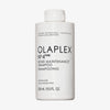 Weiße Flasche OLAPLEX N°4 FINE Bond Maintenance Shampoo mit schwarzem Text auf weißem Hintergrund.