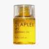 Tranparente Flasche N°7 Bonding Oil 30ml von OLAPLEX mit gelbem Öl und schwarzem Text.