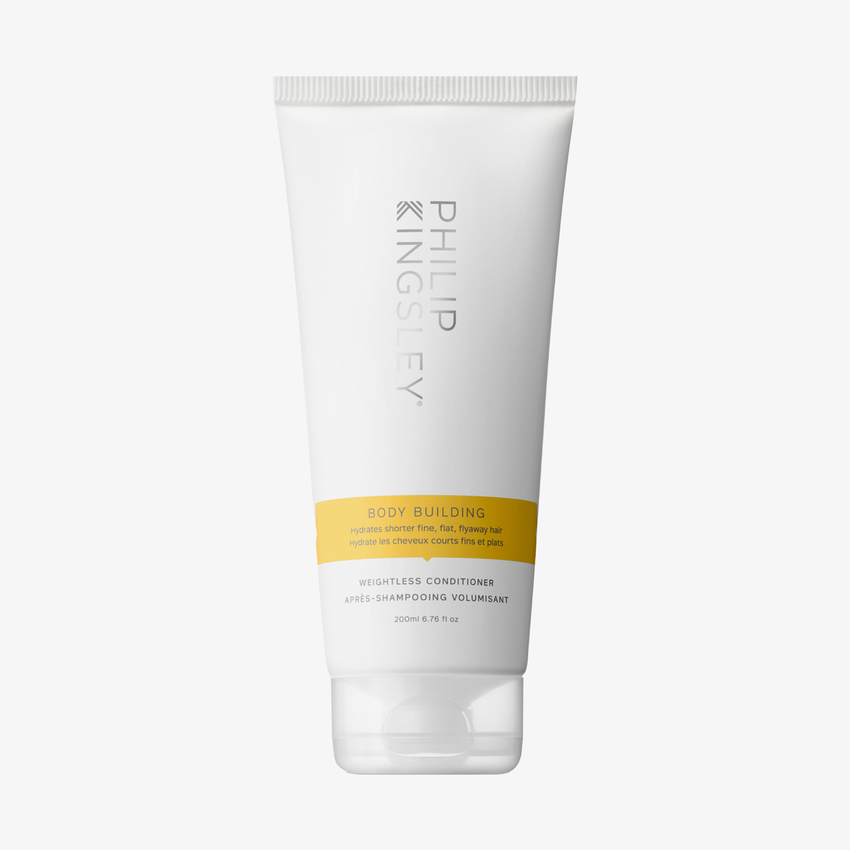 Philip Kingsley Body Building Conditioner in einer weißen Tube mit gelbem Etikett, aufrecht auf weißem Hintergrund.