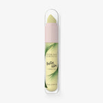 Eine Tube Physicians Formula Butter Glow Corrector in Gelb mit Palmblattdesign auf dem Etikett.