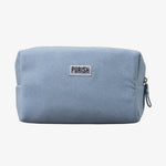 Die PURISH Cosmetic Bag - Kosmetiktasche ist eine hellblaue Tasche mit Reißverschluss und einem weißen PURISH-Etikett auf der Vorderseite.
