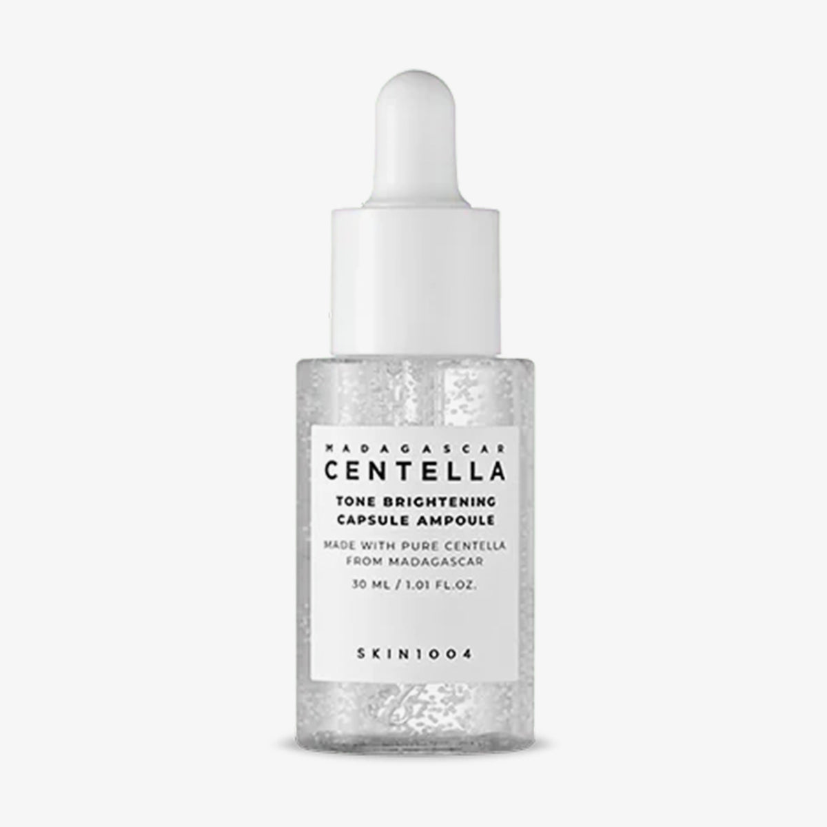 Eine durchsichtige Tropfflasche mit der Aufschrift „Madagascar Centella Tone Brightening Capsule Ampoule“, 30ml.