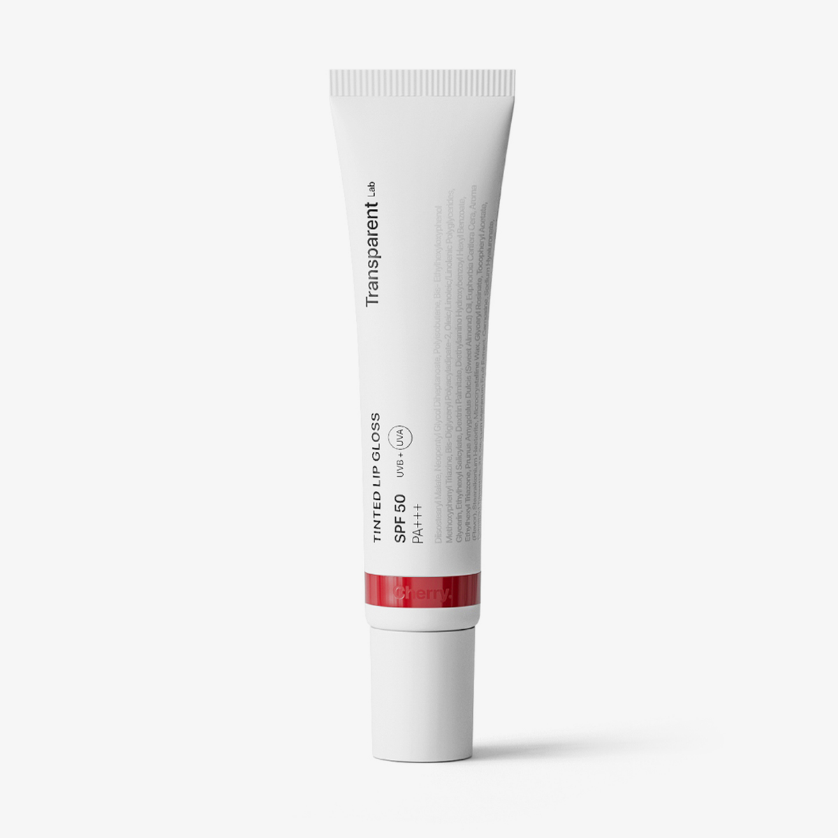 Eine weiße Tube getönter Lipgloss SPF50 mit der Aufschrift „Transparent mit PA+++“ steht aufrecht.
