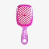 Die UNbrush Detangling Hair Brush Mini hat eine pinke, glitzernde Oberfläche mit einem wabenförmigen, belüfteten Paddel und einem passenden Griff.