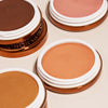 Aufnahme mehrerer Yummy Skin Blurring Balm Powder Lowlighter auf neutralem Hintergrund.