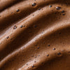 Nahaufnahme des braunen Bronzing Instant Tan Mousse mit schaumig strukturierter Oberfläche