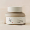 Ein Tiegel Ground Rice and Honey Glow Mask vor weichem beigem Hintergrund.