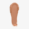 Ein Klecks des Cronzer Cream Bronzer, cremig und hellbraun, hebt sich auf weißem Untergrund ab.