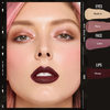 Eine Frau mit rosa Haaren trägt Danessa Myricks Beauty Colorfix Sparklers als roségoldenen Lidschatten, lilafarbenes Rouge und pflaumenfarbenen Lippenstift.