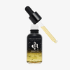 Eine Flasche Danessa Myricks Beauty Oil Original mit Tropfer, die ein goldenes Gesichtsöl enthält.