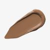 Ein brauner Farbstreifen Yummy Skin Blurring Balm Powder Shade 6.5 auf weißem Hintergrund.