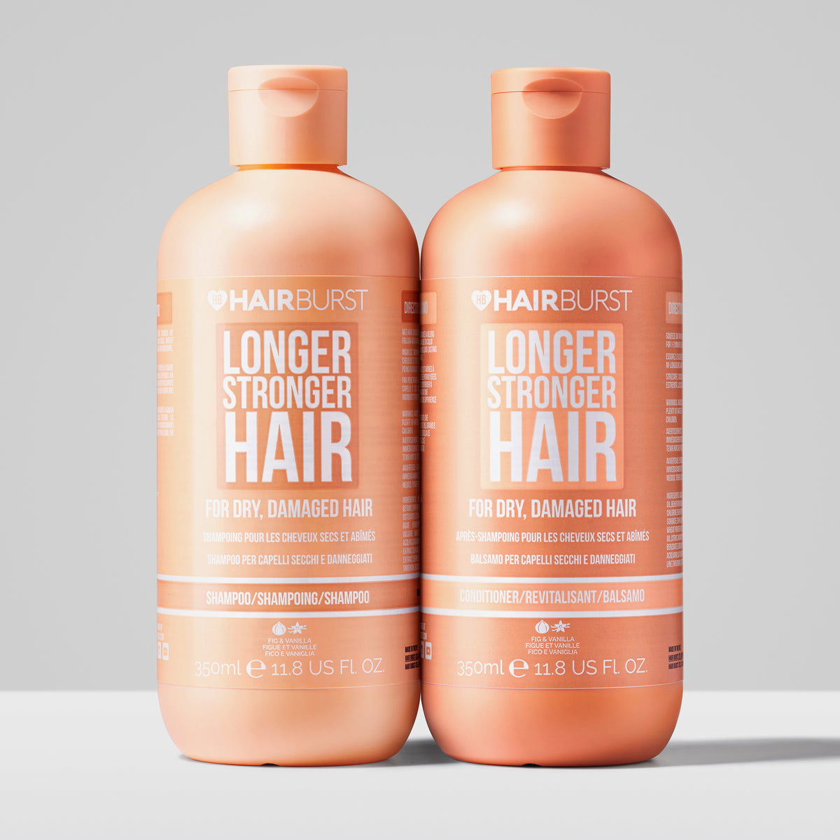 Zwei orangefarbene Flaschen Shampoo & Conditioner aus dem Shampoo & Conditioner for Dry and Damaged Hair Set.