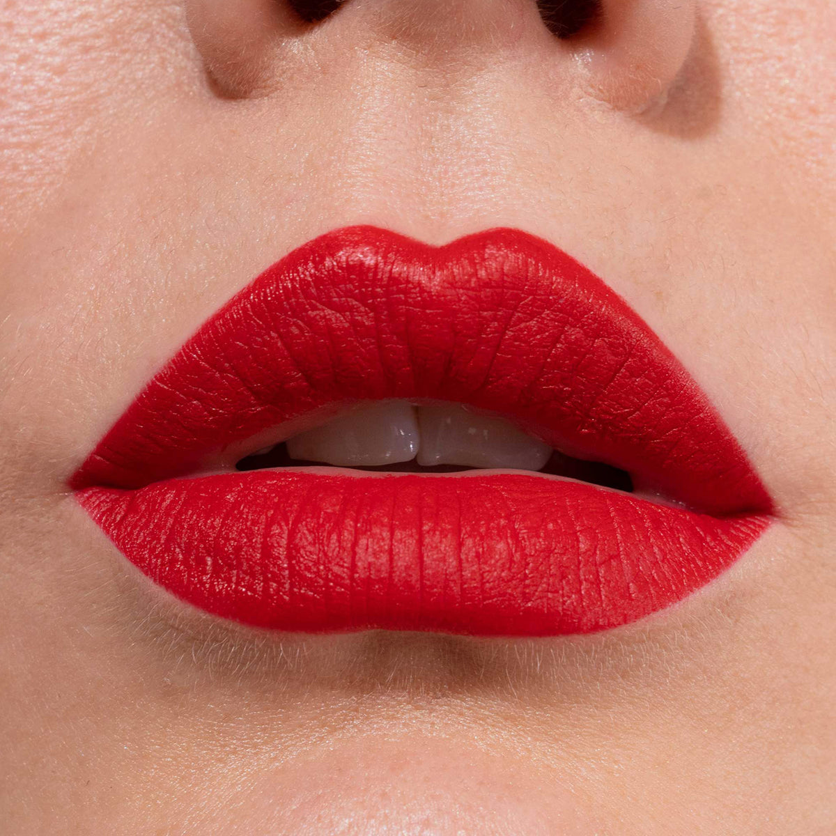 Nahaufnahme der Lippen einer Person mit intensiv rotem LH Cosmetics Crayon Anger.
