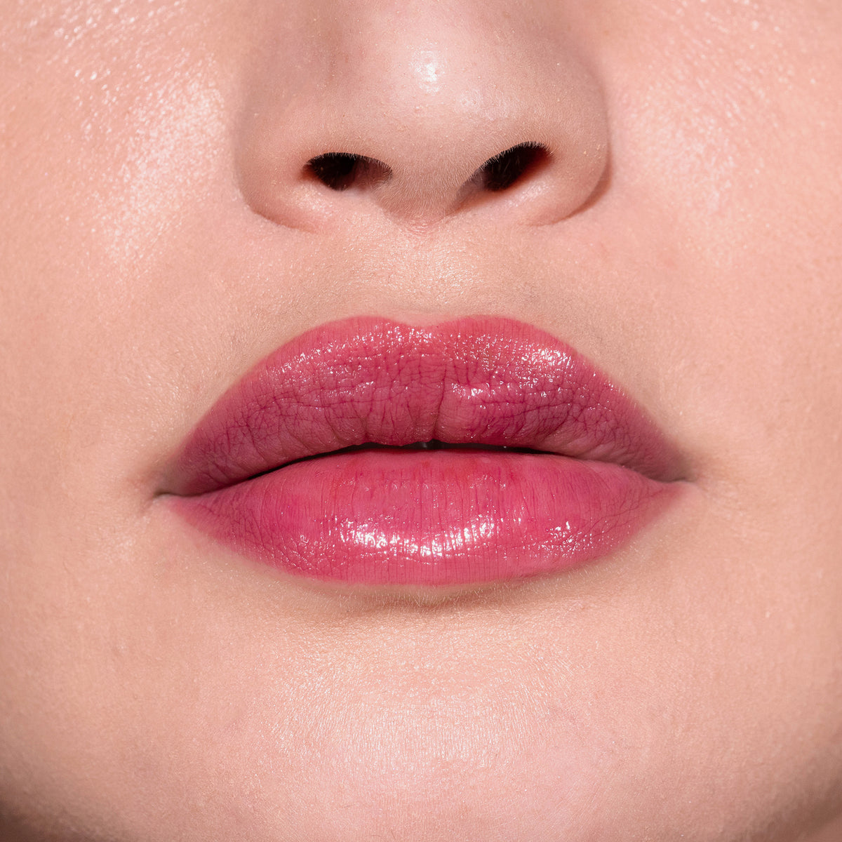 Nahaufnahme von glänzenden, beerenrosanen Lippen mit dem Fantastick Lipstick Berry von LH Cosmetics.