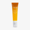Eine orangefarbene Tube der Lumene NORDIC-C [VALO] Self-Tan Drops mit einer durchsichtigen Kappe.