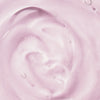 Nahaufnahme der Geltextur der NORDIC BLOOM [LUMO] Vegane Kollagen Essence von Lumene auf hellrosa Hintergrund.