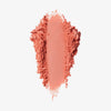Blush-Puder in der Farbe paradise, als kräftiger Farbstrich mit krümeligen, unregelmäßigen Rändern auf weißem Hintergrund.