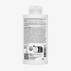 Rückseite einer weißen Flasche N°5 Bond Maintenance Conditioner mit Angaben zu Inhaltsstoffen, Gebrauchsanweisungen und Recyclingsymbolen.