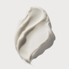 Ein cremefarbener Klecks der Textur der OLAPLEX Rich Hydration Mask auf einem schlichten weißen Hintergrund.
