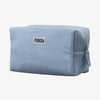 Die PURISH Cosmetic Bag ist eine hellblaue Cordtasche mit Reißverschluss und einem PURISH-Etikett auf der Vorderseite.