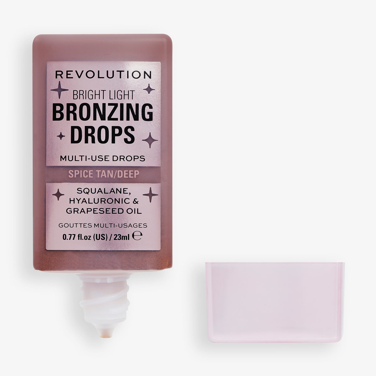 Eine geöffnete Flasche Bright Light Bronzing Drops in Spice Tan/Deep mit Deckel daneben.