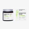 Ein brauner Glastiegel und eine weiße Schachtel der Scandinavian Biolabs Hair Hydration Mask vor weißem Hintergrund.