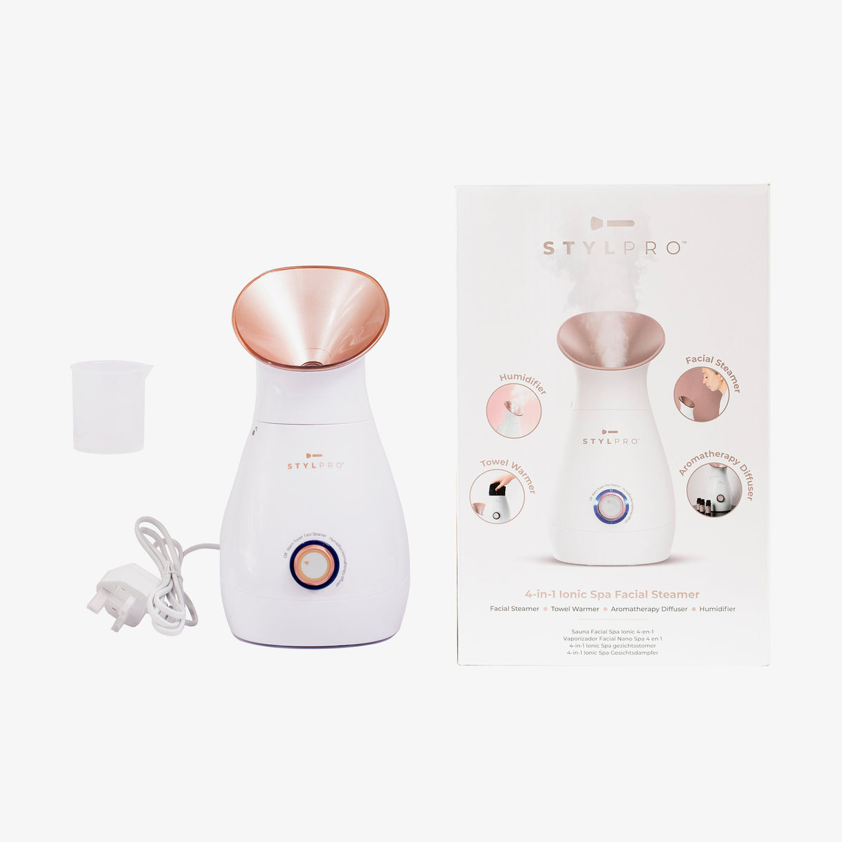 Der 4-in-1-Gesichtsdampfer mit weißem Gehäuse und roségoldener Düse neben einer Box mit Funktionen und Anleitung.