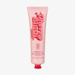 Rosa Tube des „Cherry Blush Rapid Warming Balm“ von The Fox Tan mit roten Schriftzügen und Kirschgrafik – hergestellt in Australien.