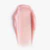 Sheen Screen Hydrating Lip Balm SPF50 in Pink auf weißem Hintergrund, mit einer glänzenden, ungleichmäßigen organischen Textur.