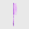 Die UNbrush Detangling Hair Brush Mini in lila Glitzer steht aufrecht vor einem schlichten hellgrauen Hintergrund.