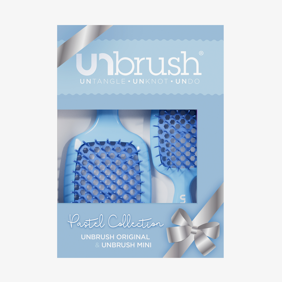 Das UNbrush Pastel Duo Set besteht aus zwei Haarbürsten in einer pastellfarbenen Verpackung mit einem silbernen Band und einem Etikett "Pastel Collection" auf der Schachtel.