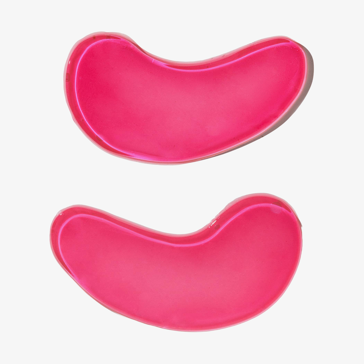 Zwei rosa, halbmondförmige Firm + Smooth – Hydrogel Eye Patches von breakout+aid.