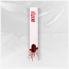 Weiße Verpackung des Dexter Lip Stain Born in Blood von Lethal Cosmetics mit rotem Text und Bluttropfen-Design vor einer  Plastikfolie.