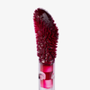 Nahaufnahme eines Applikators von Lethal Cosmetics Infinity Lip Stains, dessen weiche, strukturierte Spitze mit dunkelrotem Produkt beschichtet ist, vor einem weißen Hintergrund.