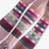 Auf drei Unterarmen befinden sich Reihen von bunten, schimmernden Lidschattenproben in verschiedenen Farbtönen und Ausführungen aus der Serpentine Palette von Lethal Cosmetics.