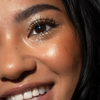 Nahaufnahme des Gesichts einer Frau mit gold glitzerndem Lidschatten Sparkl Charm von LH Cosmetics.