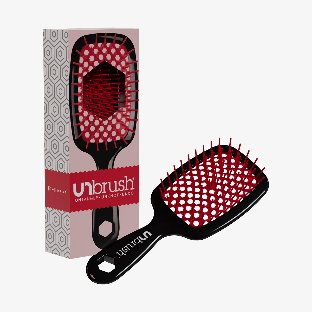 Eine schwarz-rote UNbrush Detangling-Haarbürste mit geometrischem Muster steht neben der Schachtel.