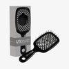 Die schwarze UNbrush Detangling-Haarbürste mit sechseckigem Muster wird neben der passenden Verpackungsbox präsentiert.