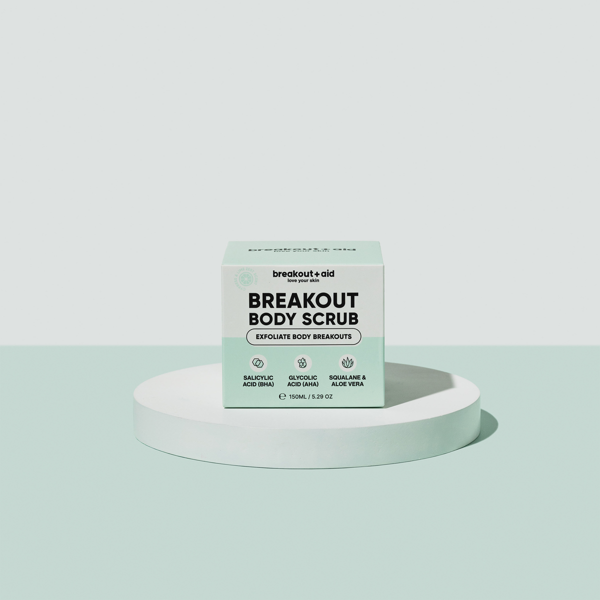 Hellgrüne Verpackung von Breakout+Aid Breakout Body Scrub mit der Aufschrift Salicylsäure, Glykolsäure, Squalan und Aloe Vera.