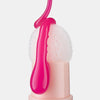 Nahaufnahme eines weißen Kissenschwamms, auf den leuchtend pinkes Lip Oil tropft, Produkt in elegantem Nude-Gehäuse vor weißem Hintergrund.