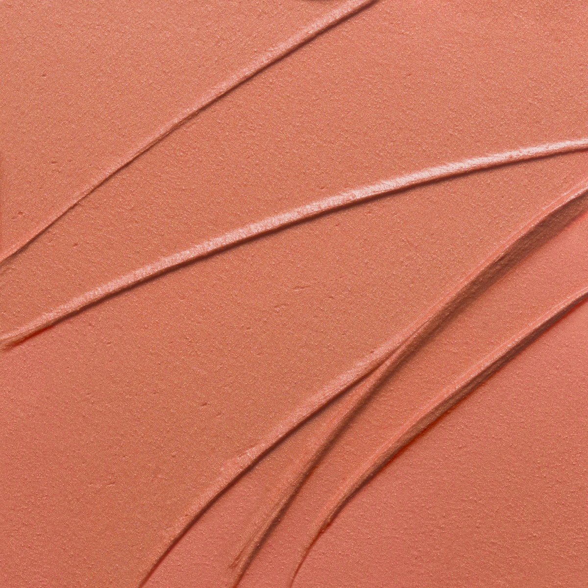 Nahaufnahme der Textur des Yummy Skin Blurring Balm Powder Lowlighter Lowkey in korall.
