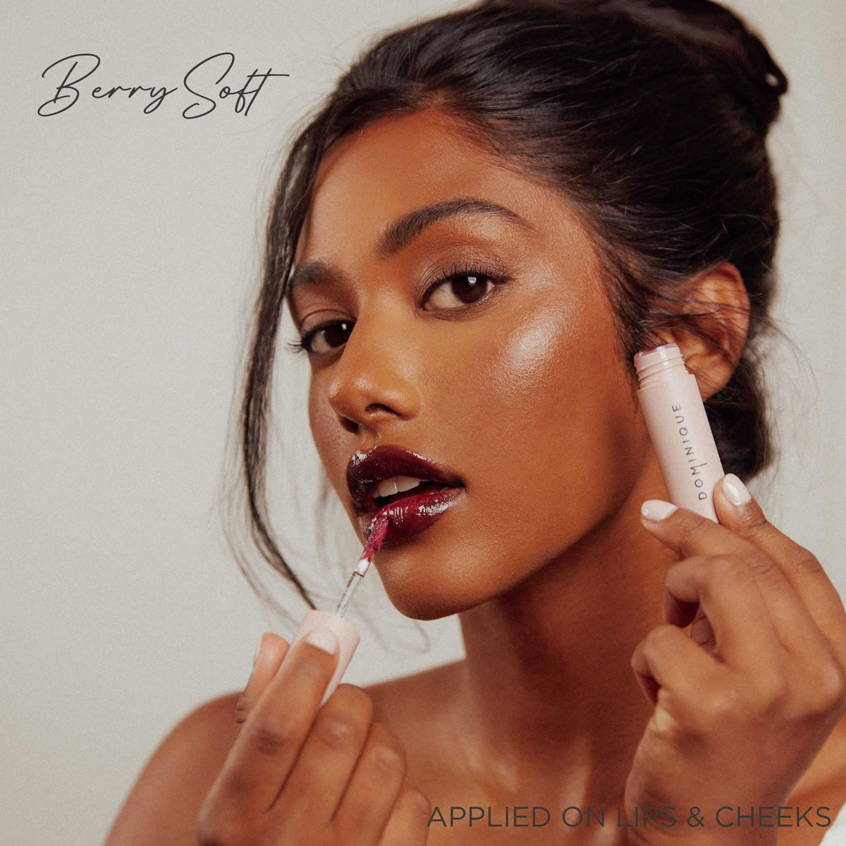 Eine Frau trägt Pillow Soft Hydrating Lip & Cheek Stain in einem Beerenton auf, wobei auf dem Bild der Text „Berry Soft“ und „AUF LIPPEN & WANGEN AUFGETRAGEN“ zu sehen ist.