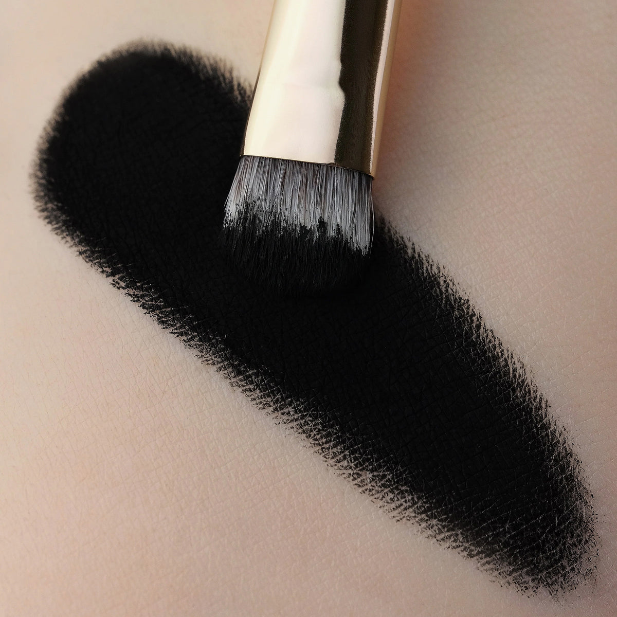 Ein tiefschwarzer Farbstreifen des Moonshadow Matte Pressed Eyeshadow auf heller Haut.