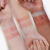 Drei Arme mit unterschiedlichen Hauttönen zeigen Swatches des The Spongebob Movie Jelly Highlighter Stick und des Blush Stick von Lethal Cosmetics.