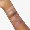 Ein Arm, der sechs Swatches von Mesauda Beauty Bare Harmony 2.0 Lidschatten in schimmernden und matten Tönen zeigt.